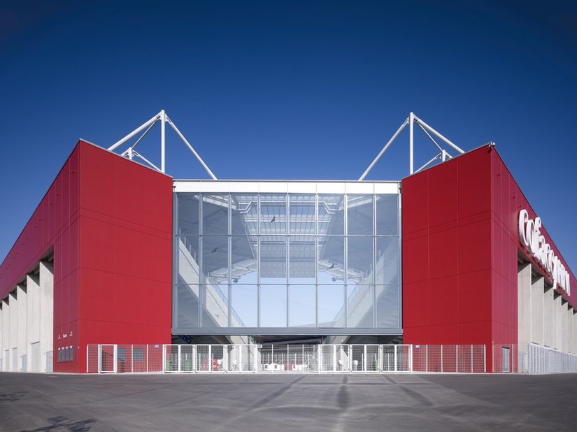 Durch die transparenten Eckpunkte zwischen den Tribünen kann man bereits das Spielfeld erahnen. Typisch für die nach traditionellem Vorbild geplante Fußballarena mit den frei stehenden Tribünen.