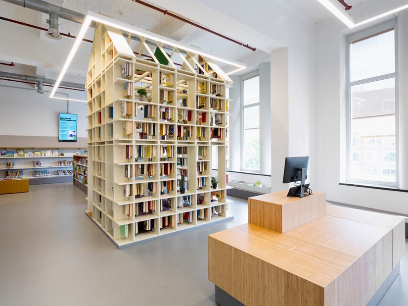 <p>Ein spielerisches „Hausregal“ erstreckt sich bis zur Decke des Ateliers für Kinder im zweiten Stockwerk. Mit den hellen Decken und Wänden wirkt der Raum offen und freundlich.</p>